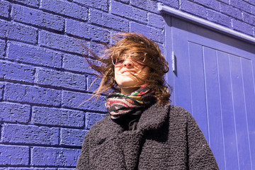 Portrait of Hipster woman with sunglasses and wind messing hair