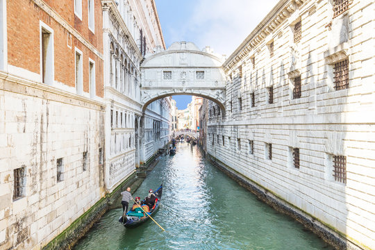 Gondolas is passing over Bridge of Sighs in Venice, Italy
