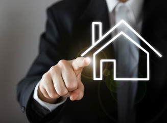 Businessman choosing house, real estate concept. Hand pressing