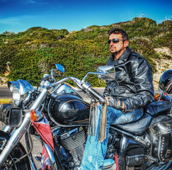 Fototapeta na wymiar man on a classic motorcycle in hdr