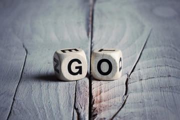 Word Go written on wooden blocks. Vintage style.