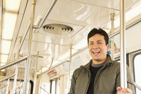 Hispanic Man Laughing On Train