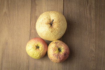 sear apple and chinese pear on wood background