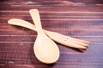wooden spoon and fork isolated on wooden background