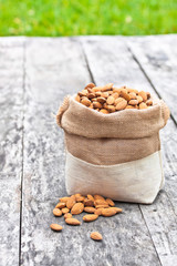 almond bag on the old table with green grass