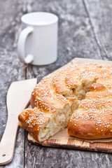 homemade spiral bread with mug on the old table