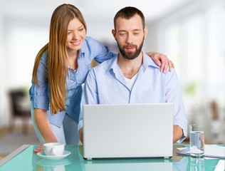 Home. Hispanic Couple Using Laptop On Desk At Home