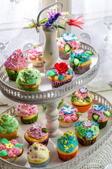 Tasty muffins with sweet decoration and cream