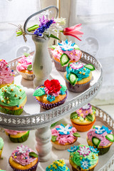 Tasty cupcakes with sweet decoration and cream