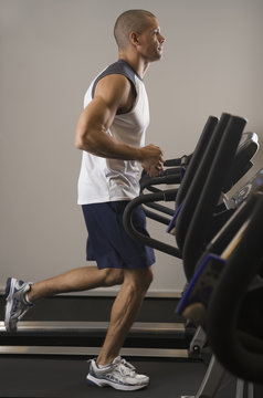 Hispanic Man Running On Treadmill