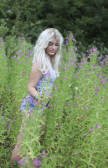 Beautiful young woman in long grass