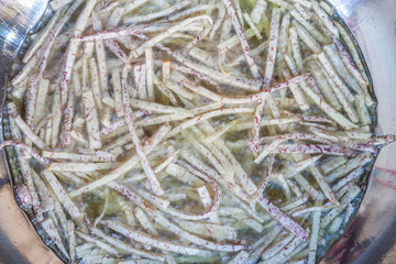 Frying sliced taro