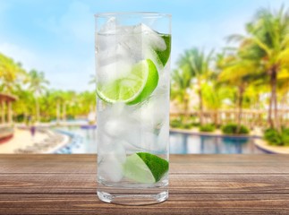 Vodka. Cocktail with ice and lime slice isolated on white