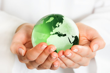 Hand holding green glass globe