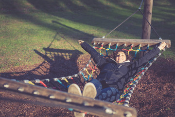 Young girl stretching and resting in hammock