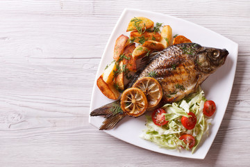 fried fish with fries and salad horizontal top view