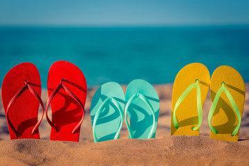 Naklejka premium Beach flip-flops on the sand