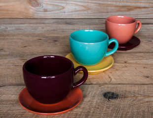 set of colorful cups and dishes and dessert