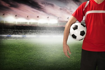 Obraz premium Soccer. Midsection of a soccer player holding a ball