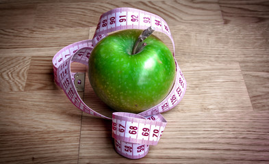 Apple juice with apples on wooden background