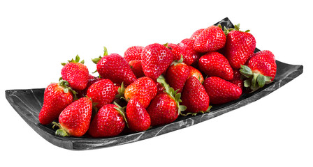 Tasty  strawberries freshly collected in a wooden plate isolated