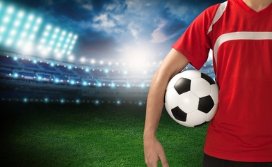 Naklejka premium Soccer. Midsection of a soccer player holding a ball
