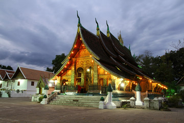 Fototapeta na wymiar Colorful Wat Xieng thong temple at dusk in Luang Prabang, Loas