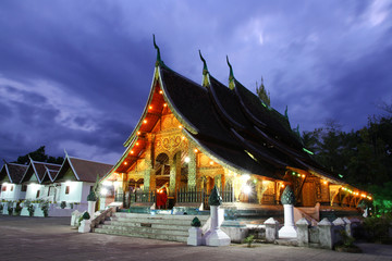 Colorful Wat Xieng thong temple at dusk in Luang Prabang, Loas