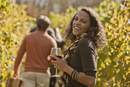 Friends drinking wine in vineyard