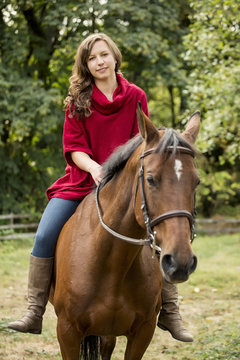 Caucasian woman riding horse outdoors