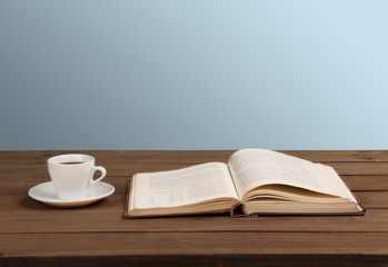 Book. Cup of coffee and a book on a wooden table