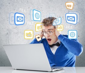 Man. Astonished boy working on laptop