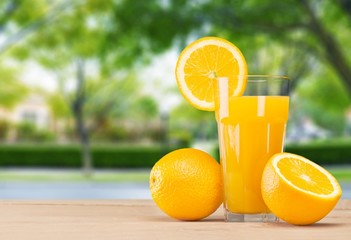 Background. Fresh orange juice on wooden table over grunge