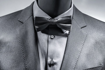 Close up of bow tie over elegant grey suit. Black White