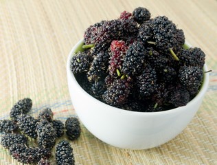 Fresh Mulberry in Bowl on Straw Mat