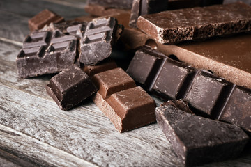 Set of chocolate on wooden table, closeup