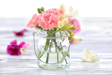 Beautiful spring flowers in glass bottle