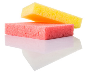 Red and yellow dish washing sponge over white background