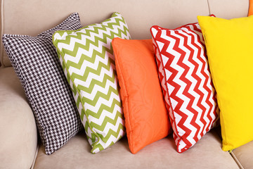 Colorful pillows on sofa close up
