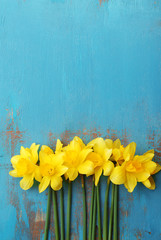 Beautiful bouquet of yellow daffodils on wooden background © Africa Studio