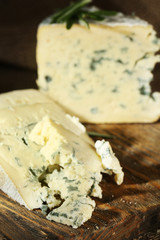 Blue cheese on wooden cutting board. closeup