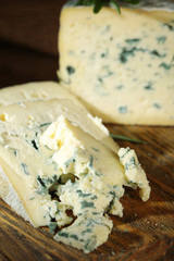 Blue cheese on wooden cutting board. closeup