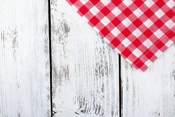 Checkered napkin on wooden table background