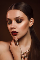 Beauty portrait of woman with gold makeup