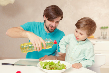Father and son make salad dressing