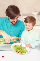 Father and son make salad dressing