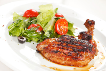 Roasted chicken leg with salad