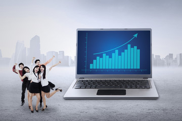 Businessteam and business chart on laptop