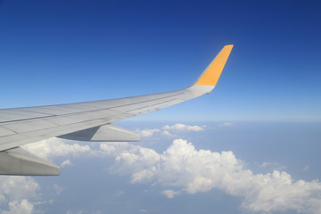 Fototapeta na wymiar Wing of an airplane flying above sky