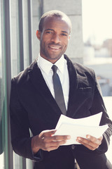 Fototapeta premium portrait of happy black man in business attire
